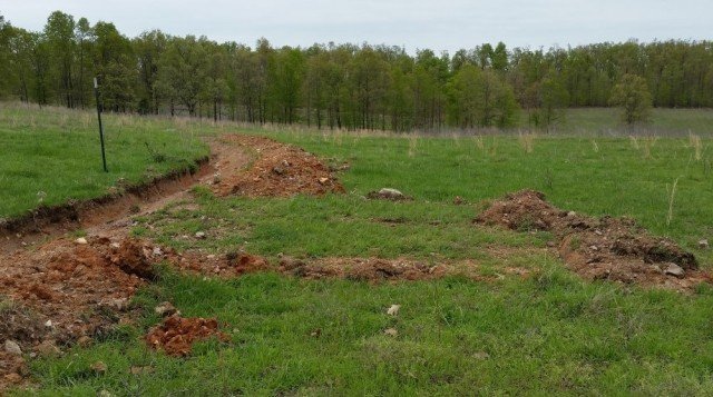 Berm removal to make spillways