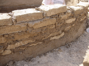 Mudbrick-wall-bound-with-mortar-and-in-the-process-of-being-covered-with-mud-plaster (1)